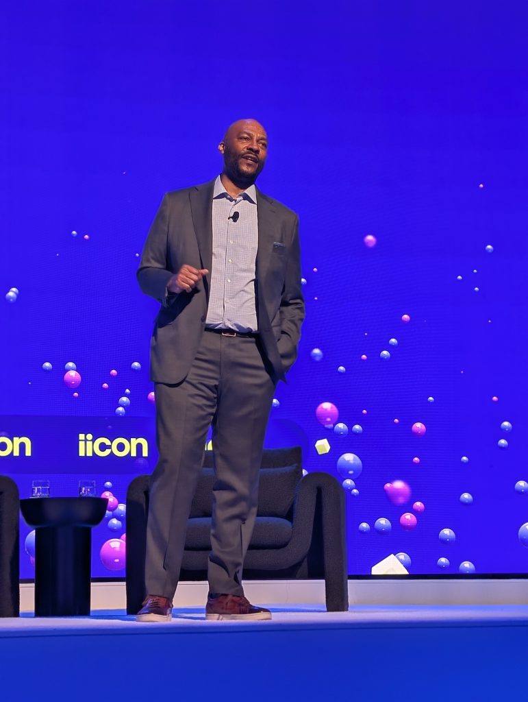 Stanley Pierre-Louis speaking on stage at iicon