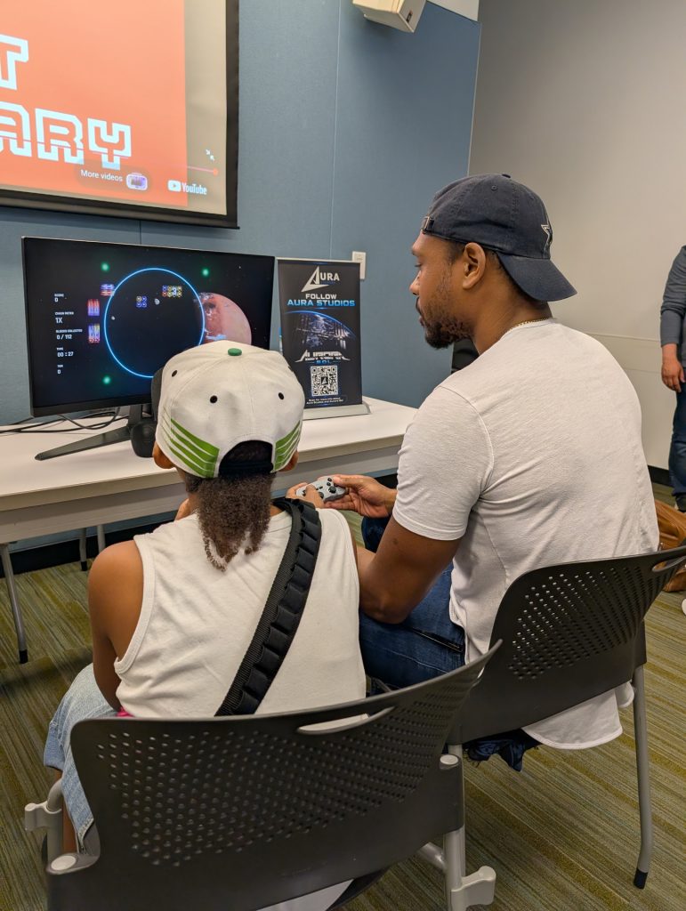 Aura Studios' original co-founder Chris Hines and a child playing Aurora Sol
